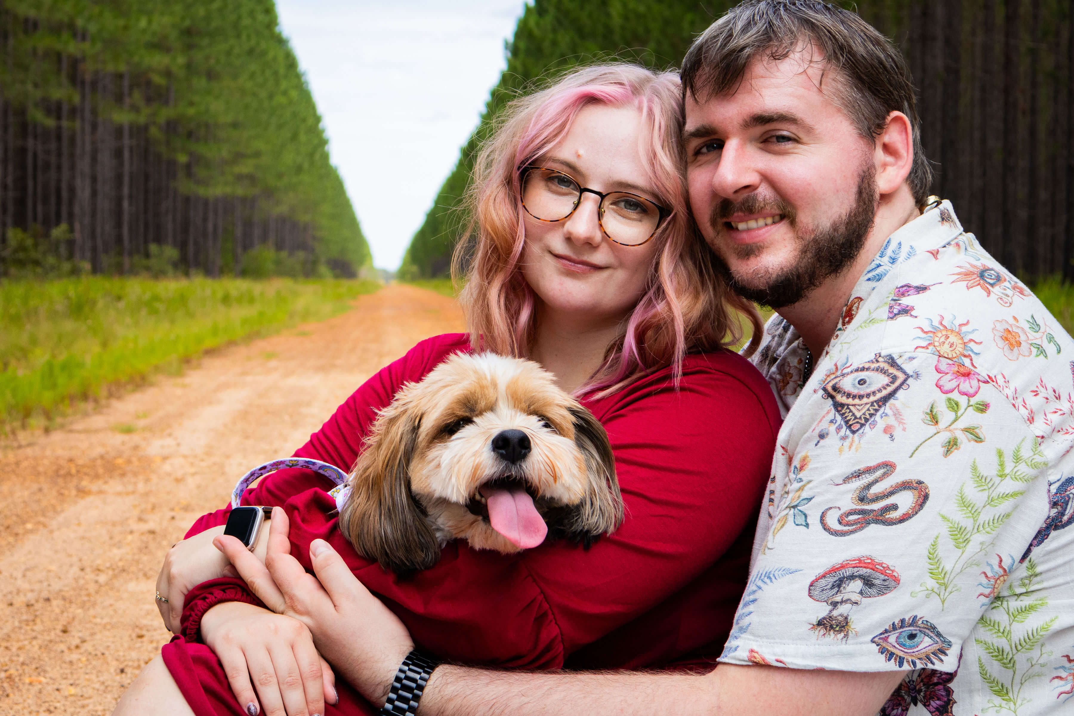 a loving couple holding their fur baby