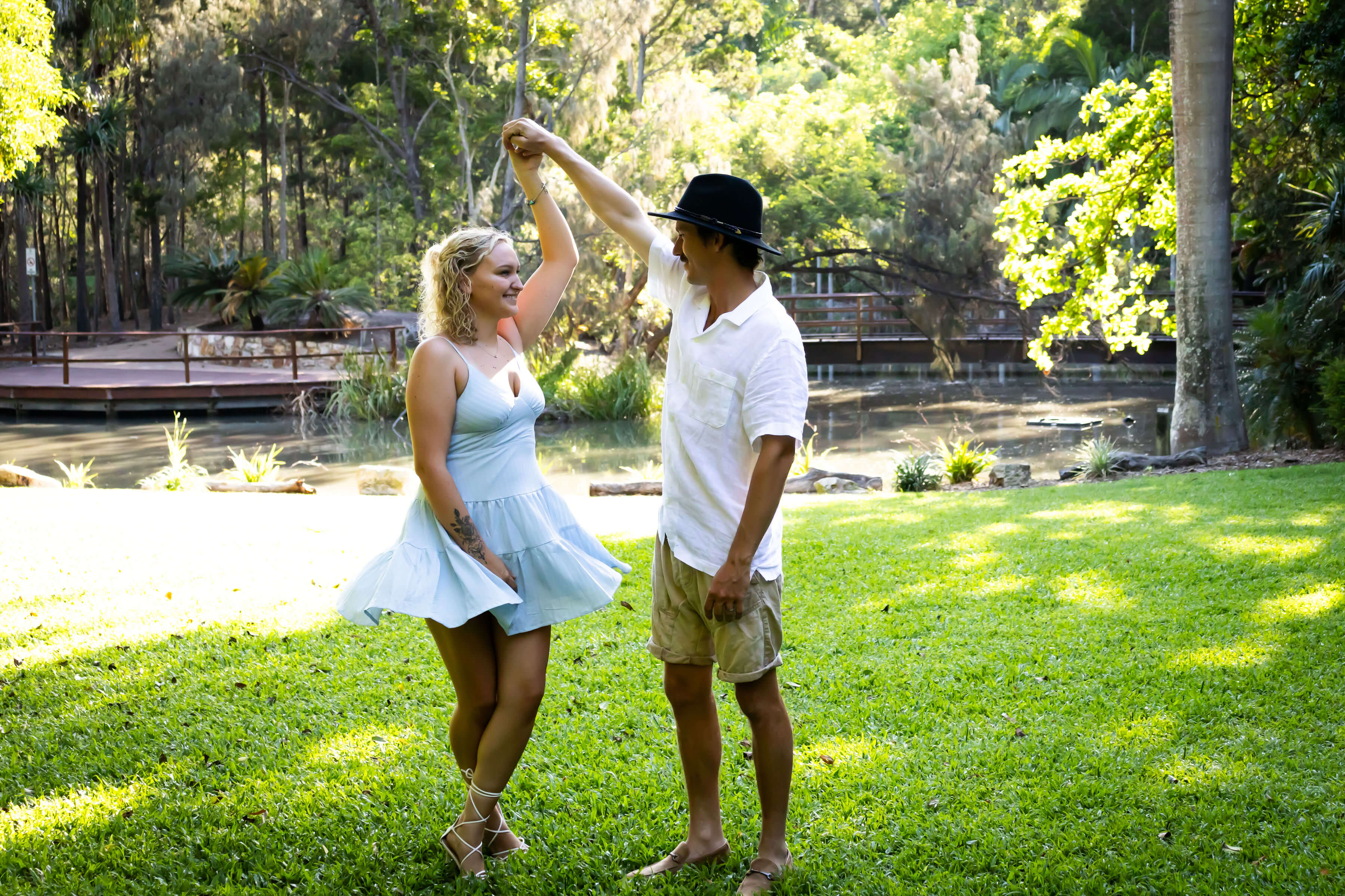 a loving couple dancing in the park