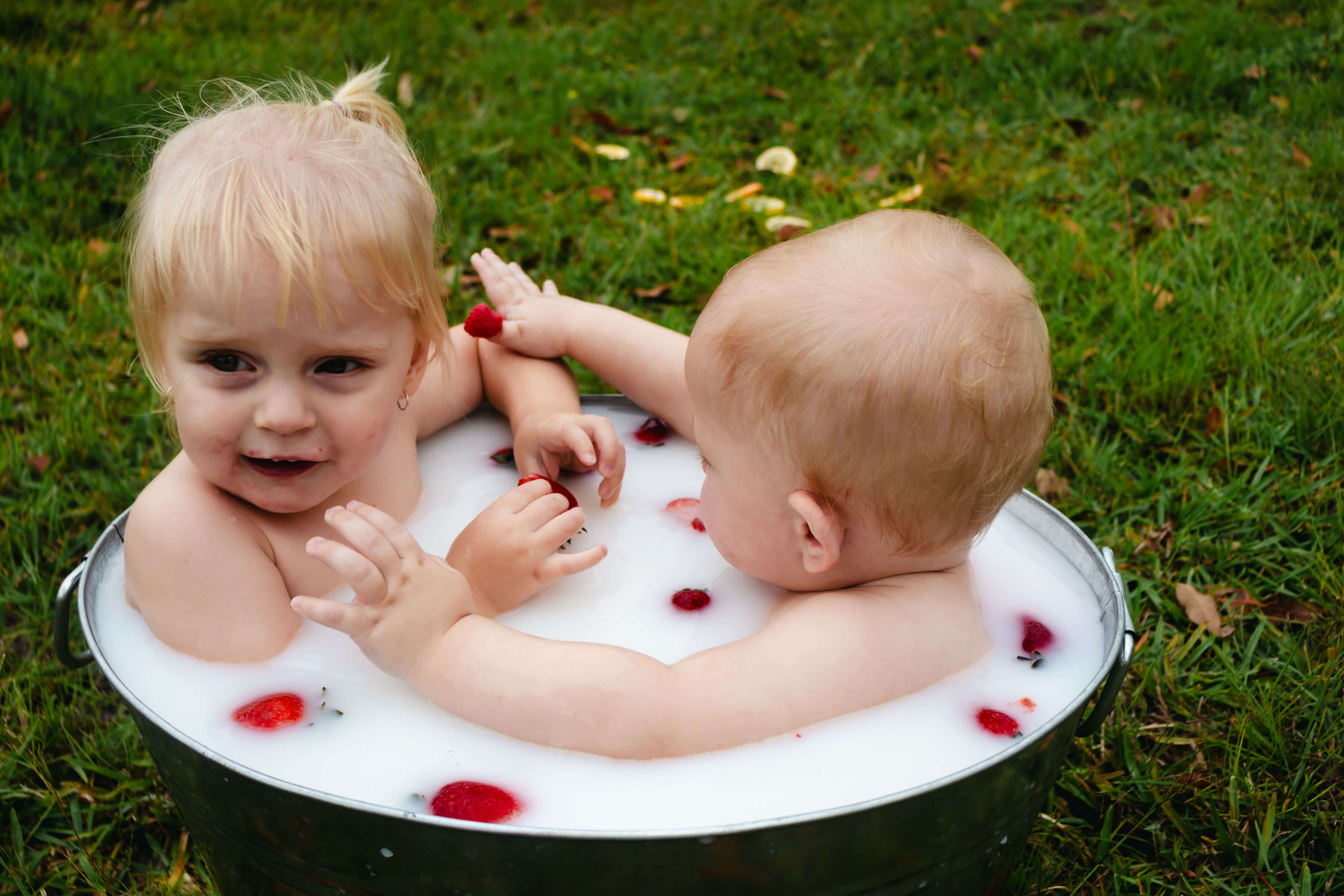 two babies in a milk bath