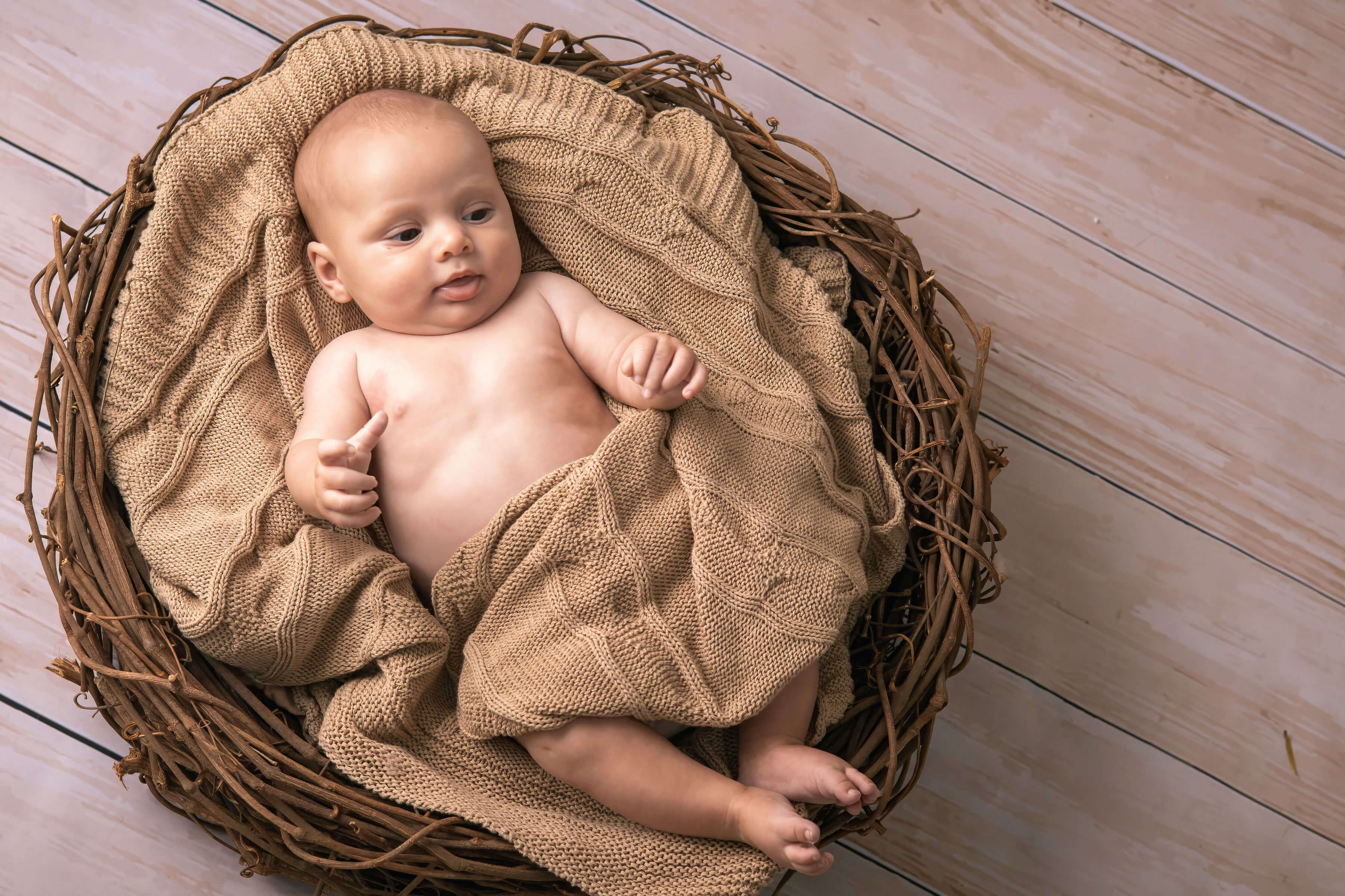 a baby laying in basket