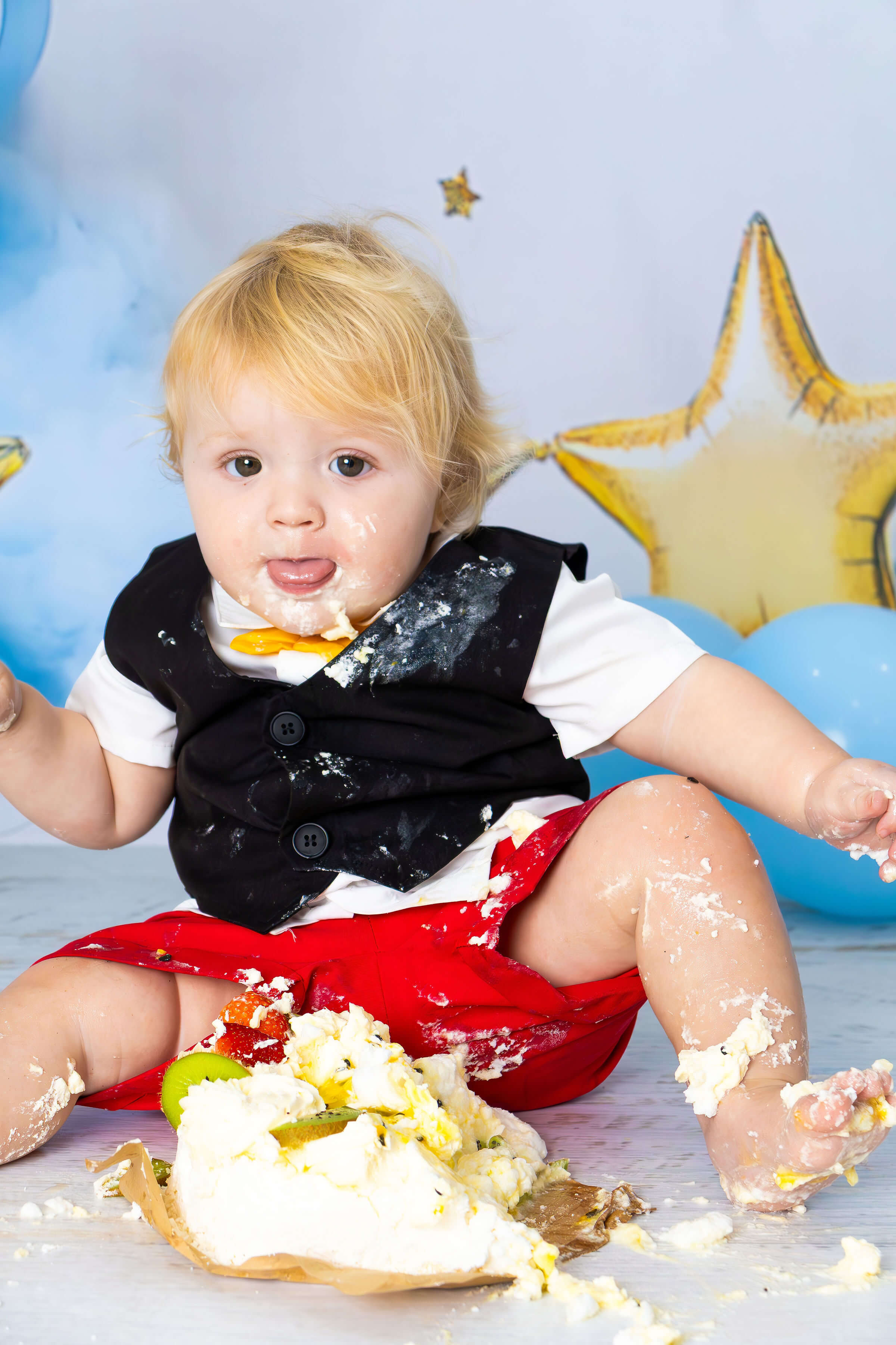 a baby smashing a cake